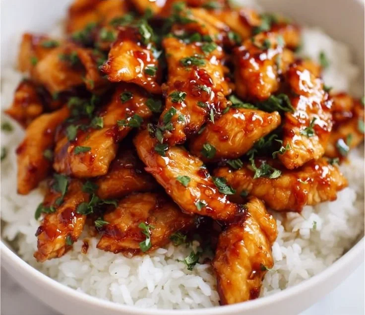 Delicious amazing honey garlic chicken served on a plate with garnishes