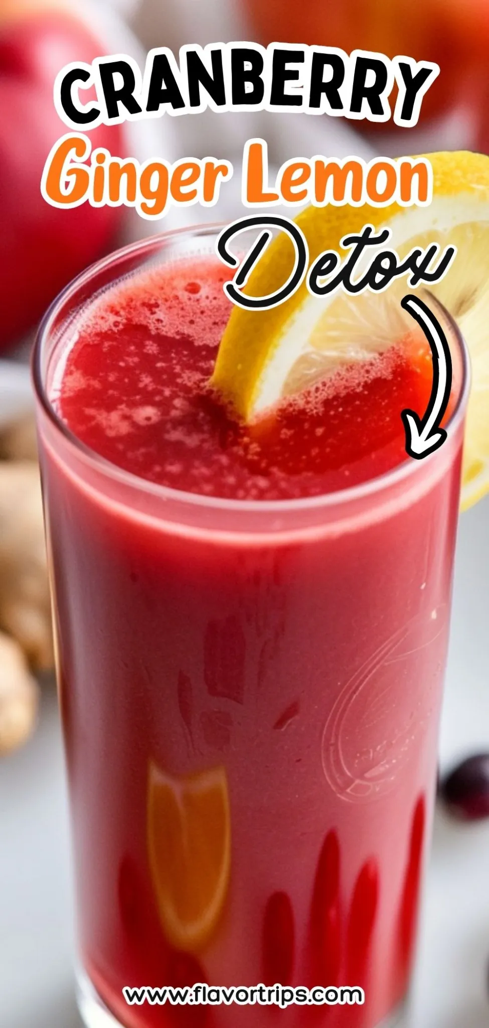 Tall glass of vibrant cranberry ginger lemon juice with lemon slice, surrounded by apples and fresh ginger