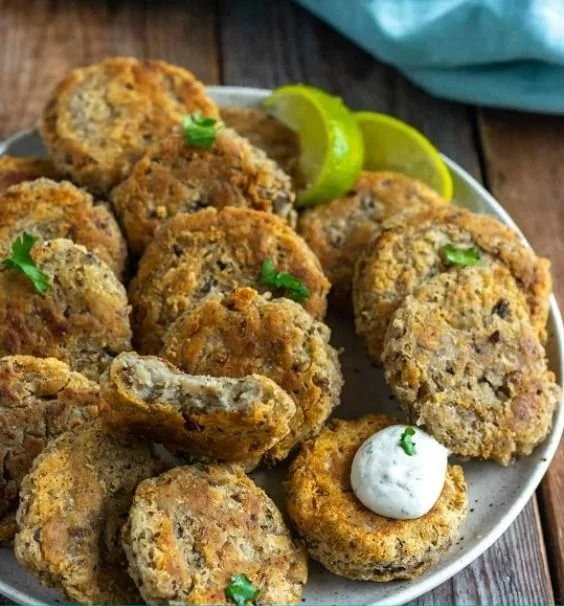 Homemade Black-Eyed Pea Fritters served on a plate with dipping sauce