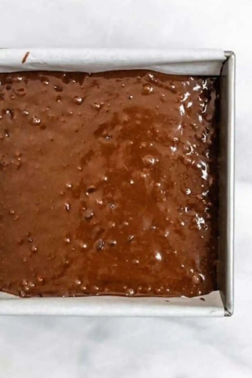 thick chocolate batter being mixed for fudgy gluten‑free brownies