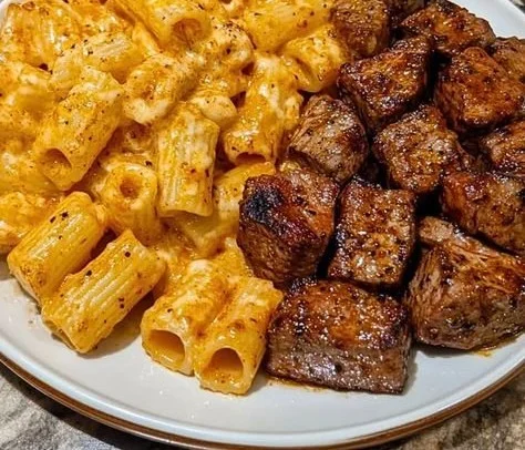 Cajun steak tips with cheesy rigatoni in a flavorful dish