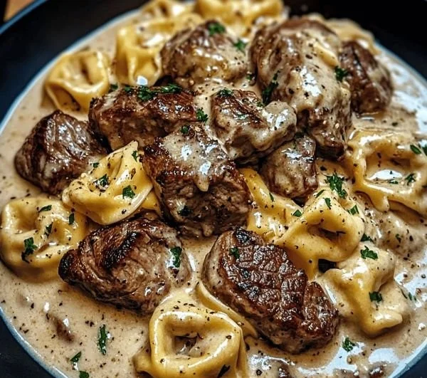 Cracked Garlic Steak Tortellini in creamy sauce served on a plate