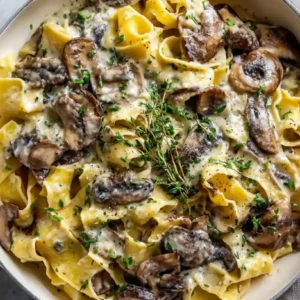 creamy Mushroom pasta (Vegan & GF) pappardelle pasta with herbs in white pan