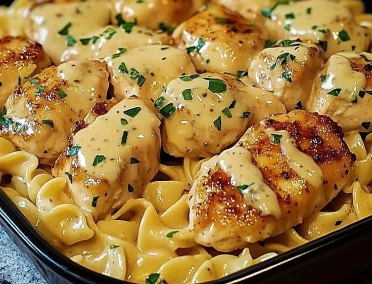 One-pan chicken served with buttered noodles, a simple and delicious meal.