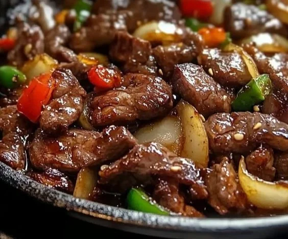 Sizzling Chinese pepper steak with onions served on a plate