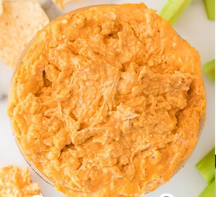 Delicious slow cooker buffalo chicken dip garnished with green onions.