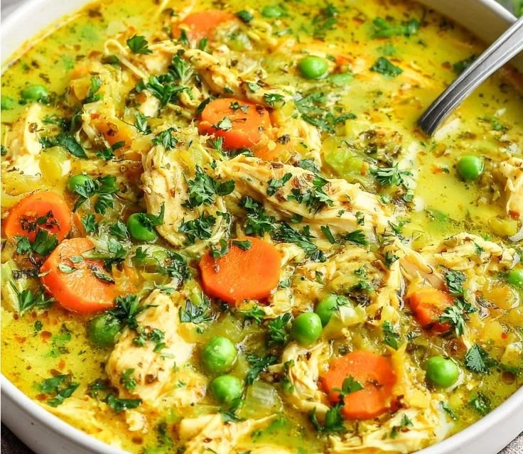 Bowl of anti-inflammatory turmeric chicken soup with herbs and spices
