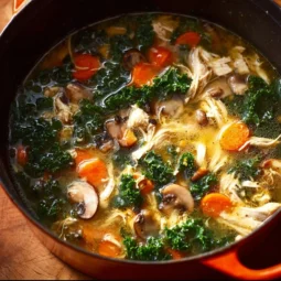 Bowl of Detox Immune-Boosting Soup filled with colorful vegetables and herbs.