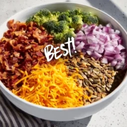 Bowl of Keto Broccoli Salad with creamy dressing and toppings