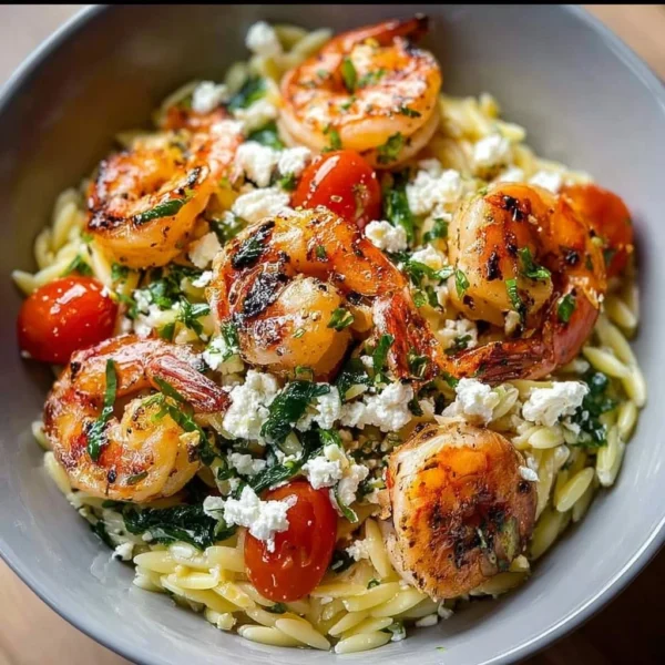 Lemon Feta Orzo Shrimp served in a bowl, garnished with fresh herbs.