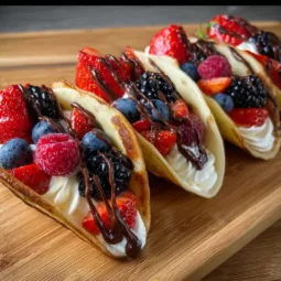 Delicious pancake tacos filled with fresh ingredients on a wooden table.