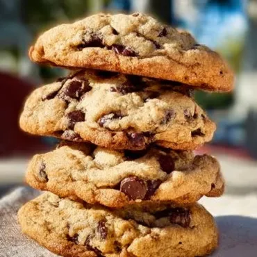 Delicious soft-batch chocolate chip cookies stacked on a plate.