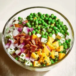 Delicious cold pea salad with fresh herbs and vegetables
